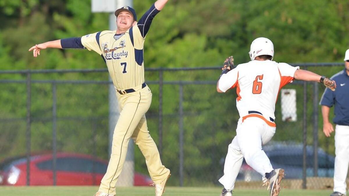Marcos Collazo (6) of Southern Lee steps on to the first base against a missed catch from Jake Thomas (7) of Lee County. The Southern Lee Cavaliers played the Lee County Yellow Jackets in a baseball game that took place in Sanford, N.C. on Friday, April 29, 2016.