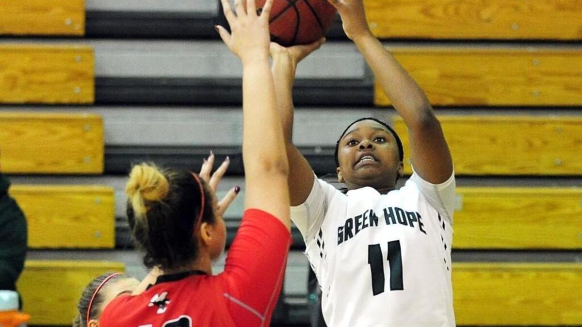 Green Hope’s Milia Sparrow (11) shoots a jumper over Middle Creek's Makayla Patrick (40) during the girls basketball game, which was played on Tuesday, January 5, 2016 in Cary. Green Hope won 49-21.