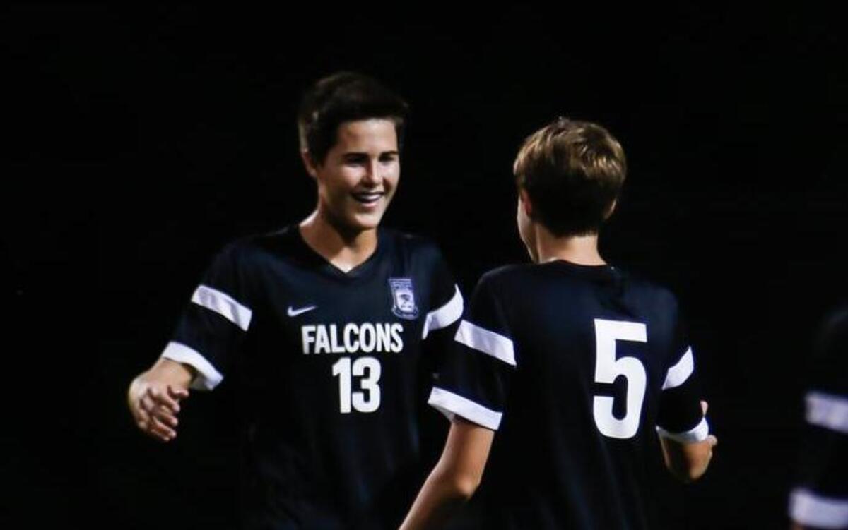 Green Hope's Camden Holbrook (13) celebrates his game-winning goal on a penalty kick with Jacob Sciandra (5) following Green Hope's soccer game at Sanderson on Tuesday, August25, 2015. Green Hope won the game 2-1.