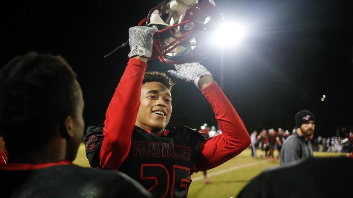 Middle Creek's Daniel Jackson claps for the student section as time runs out in Millbrook's playoff football game at Middle Creek on Friday, November 20, 2015. Middle Creek won the game 35-14.