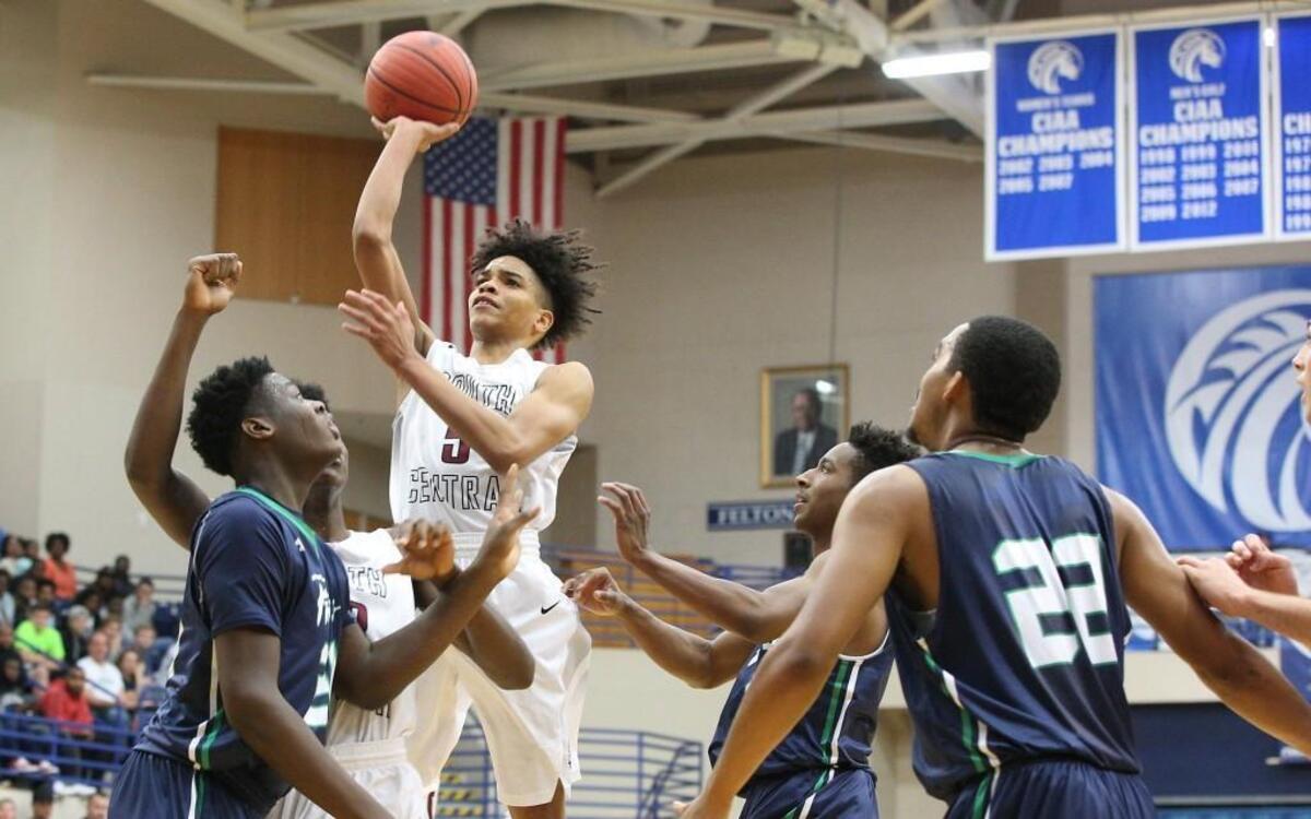South Central's Shykeim Phillips (5) shoots over Leesville Road's RJ Wilson (24) in the lane during the Leesville Road Pride high school basketball game with the South Central Falcons high school , March 4, 2017, in the NCHSAA East Regional finals in Fayetteville , N.C. Leesville Road won the game 44 - 43.