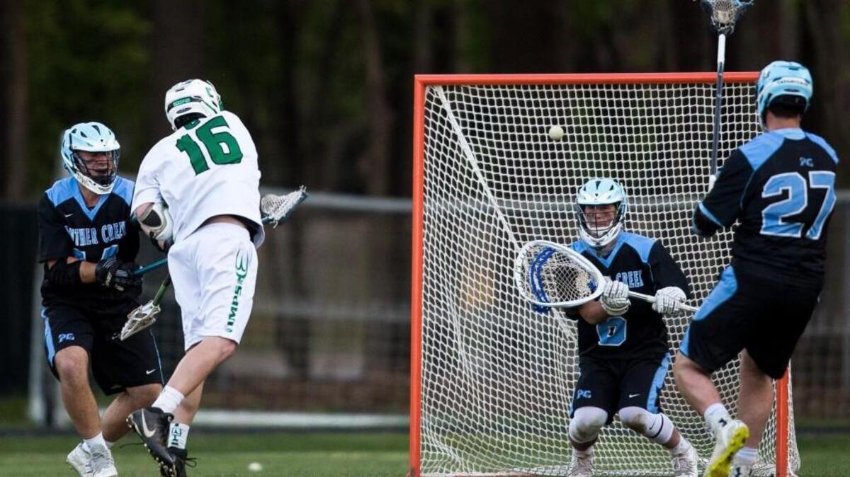 Cary’s Greg Wycoff (16) scores a goal against Panther Creek goalie Nick DeFrancesco (6) during a high school lacrosse game in Cary, N.C. on Tuesday, Apr. 5, 2016.