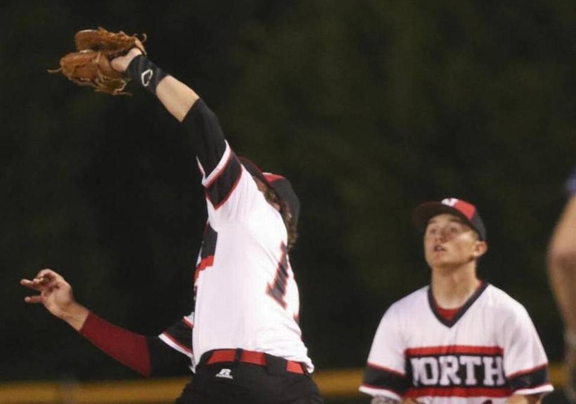 North Johnston's Logan Hayes (right) makes a tough catch looking into the lights at Hunt.
