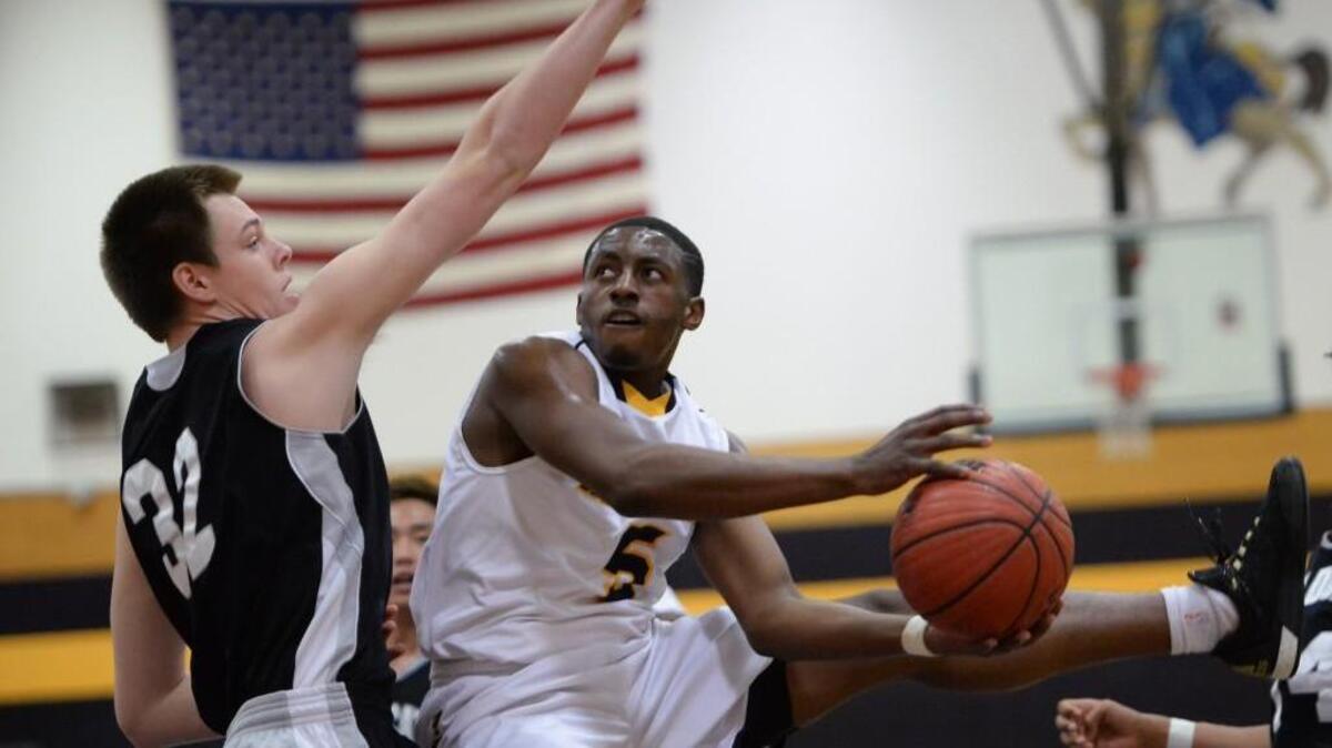 Jalen Johnson (5) of Northern drives to the basket against John Saylor (32) of East Chapel Hill. The Northern Knights played the East Chapel Hill Wildcats in Durham, N.C. on Tuesday, January 5, 2016. Northern won 62-56.