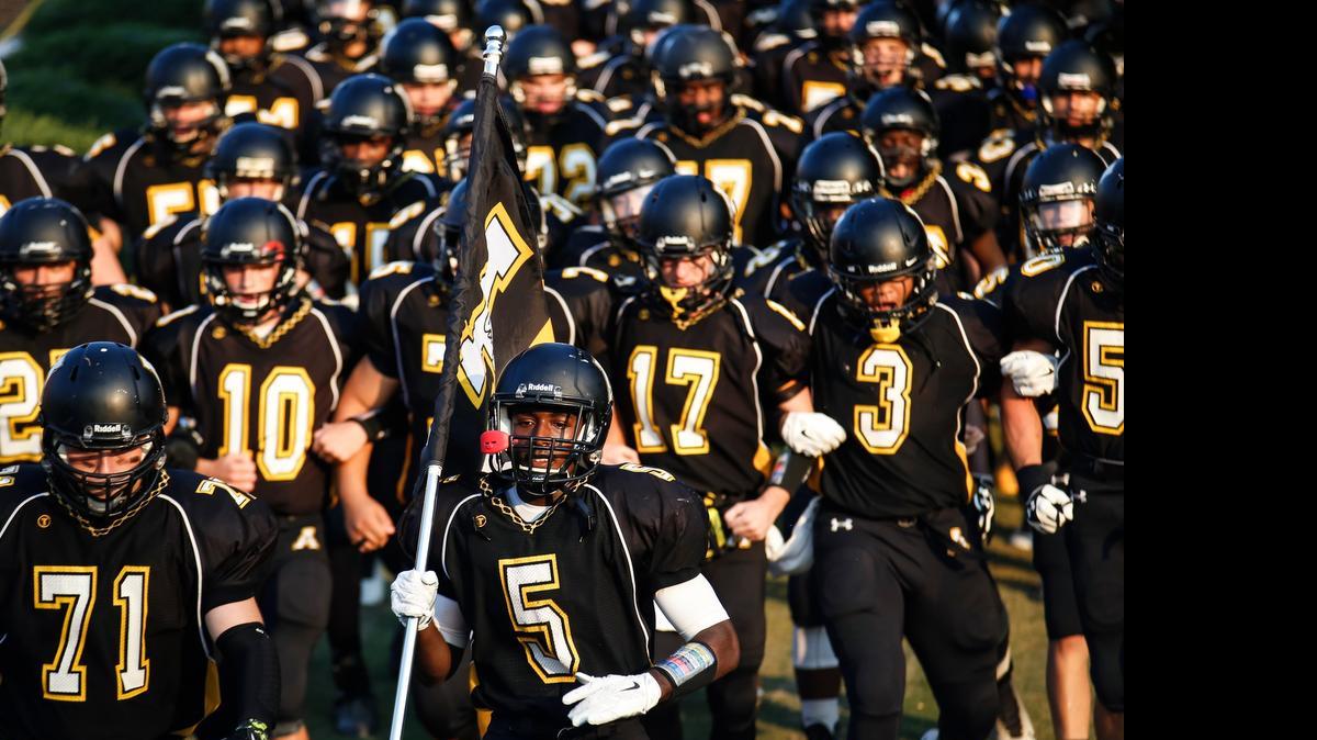 
Apex back Isaiah Totten (5) leads the team onto the field before the start of the game. The Leesville Road Pride football team played at the Apex Cougars on Thursday, August 28, 2014. Apex won the game 44-14 on the strength of Totten's five rushing touchdowns.
