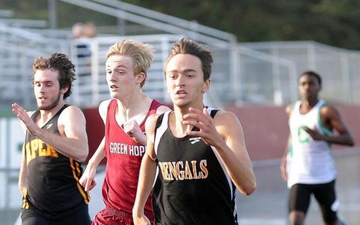 
Fuquay-Varina’s T.J. Bleichner (right) crosses the finish line first in the men's 400 meter dash during the Southwest Wake Athletic Conference Championships in Cary on Wednesday, April 22, 2015.
