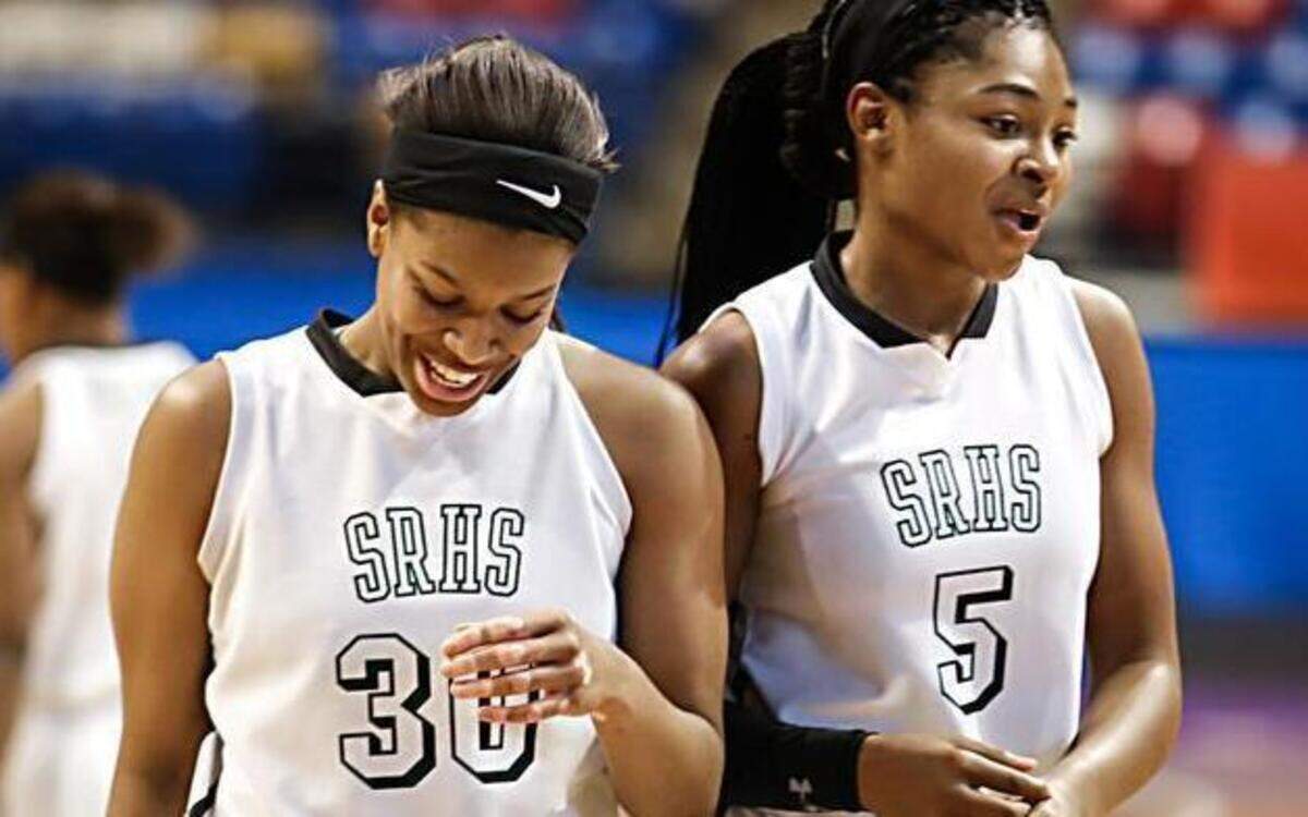 
Southeast Raleigh's Cherelle Turrentine (30) and Jade Phillips (5) laugh after Turrentine was fouled on a shot attempt late in the NCHSAA quarterfinals between Athens Drive and Southeast Raleigh in Fayetteville, NC, on Saturday, March 6, 2015. Southeast Raleigh won the game 71-59.

