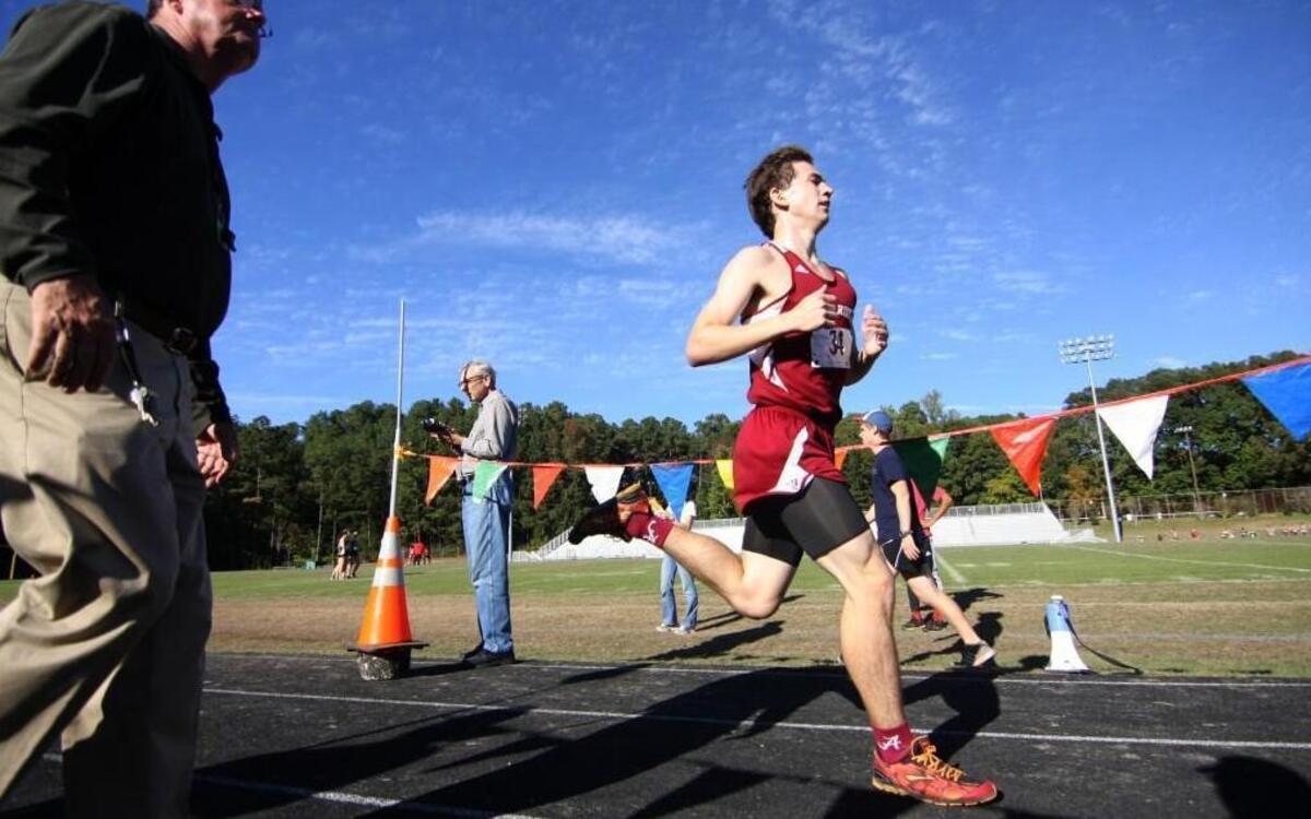 Men’s winner Ian Elliot of Cedar Ridge cruises across the finish line at the Big 8 Conference’s cross-country championship Wednesday at Northwood High School in Pittsboro.
