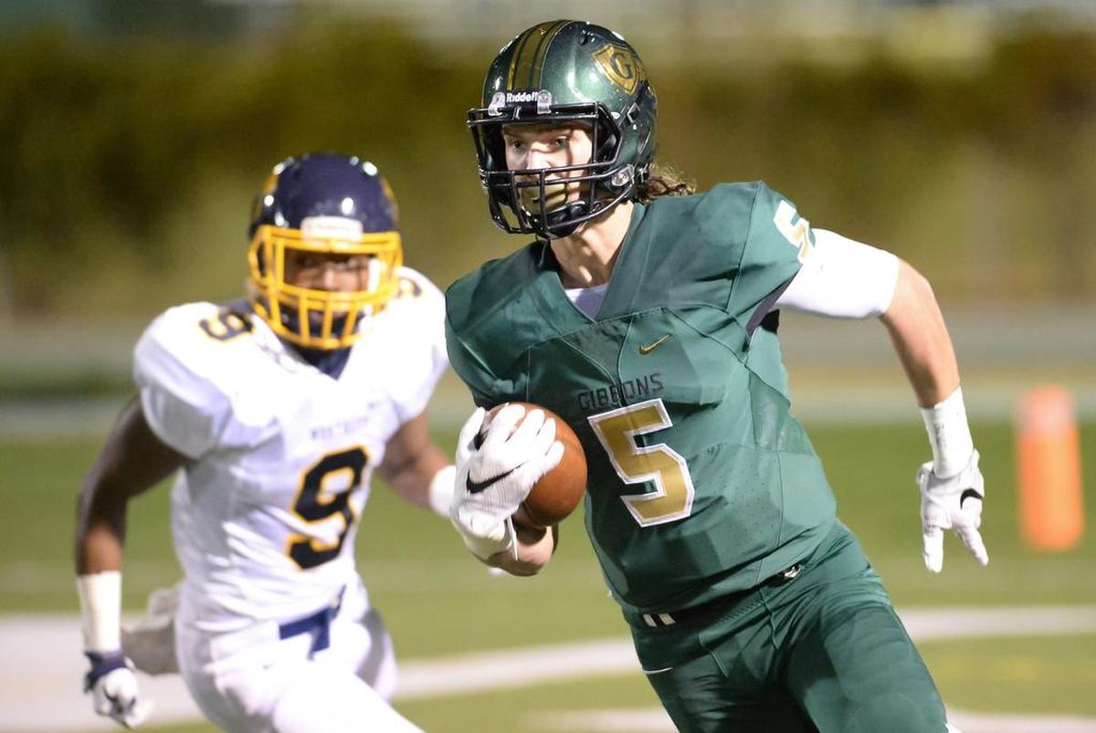Jack Biestek (5) of Cardinal Gibbons carries the ball against the pursuit of Thomas Gongs (9) of Northern. The Cardinal Gibbons Crusaders played the Northern Knights in a football game that took place in Raleigh, N.C. on Friday, November 4, 2016. Cardinal Gibbons won 25-7.