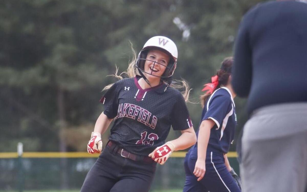 Wakefield's Bella Buccellato (13) celebrates a home run as she rounds third base with head coach Amanda Unklesbay during Leesville Road's softball game at Wakefield on Thursday, March 30, 2017. Wakefield won the game 5-2.