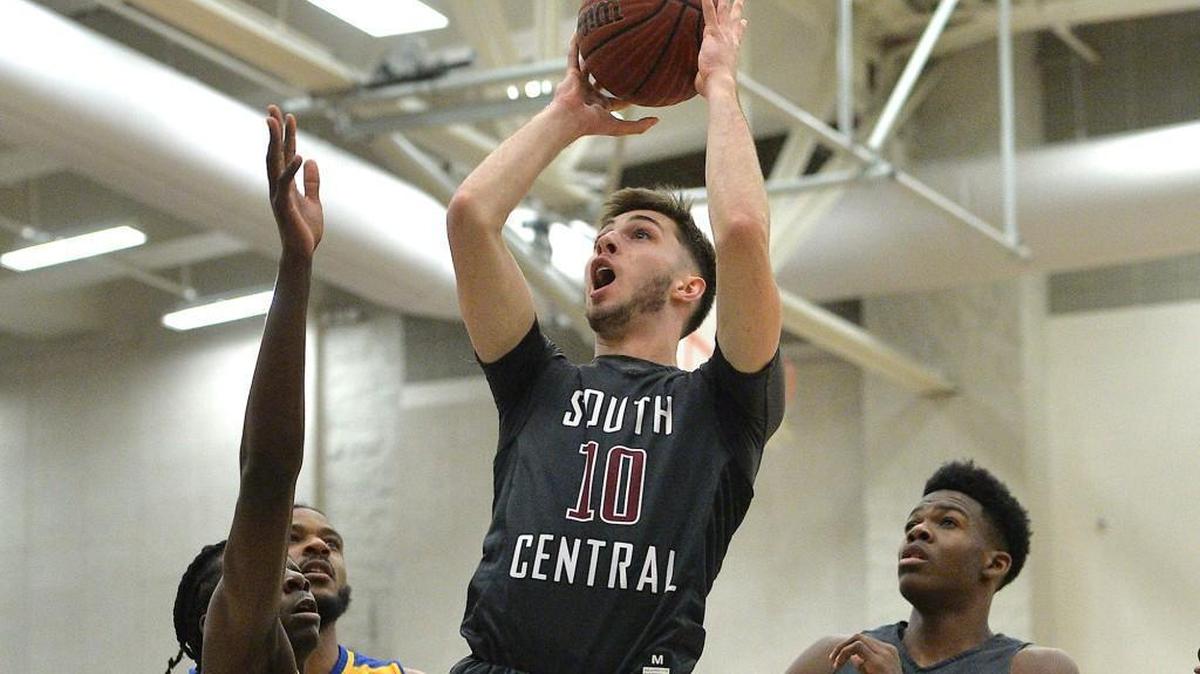 South Central's Luke Davis (10) pulls up for the jump shot over Garner's Sal-Bay Young (20) during the first quarter. The South Central Falcons took on the Garner Trojans in the fourth round of the NCHSAA4A boys basketball play offs in Garner, N.C. on February 27, 2018. South Central edges Garner 69-67.