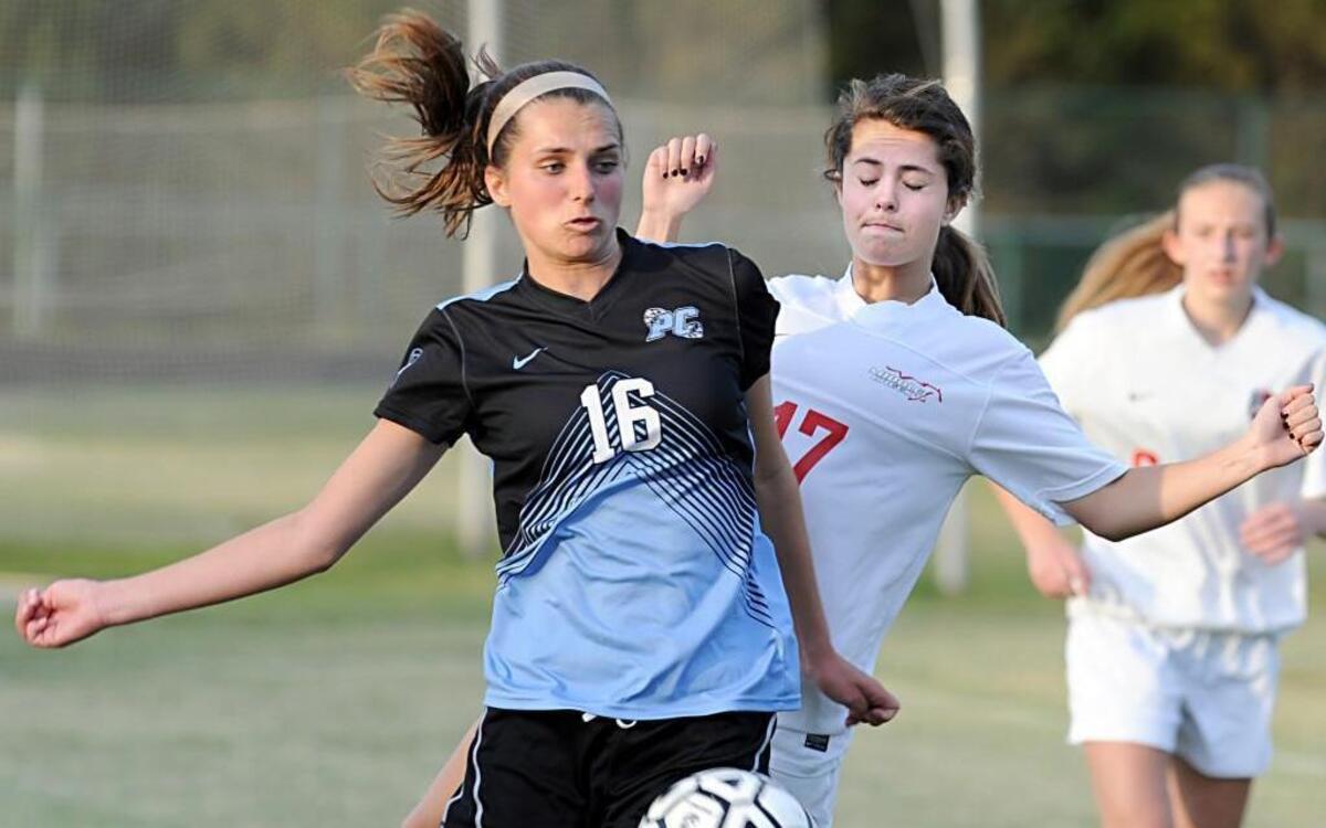 Panther Creek's Sydney Rucker (16) moves the ball past Middle Creek's Anna Southwick (17) during the girls soccer game game, which was played in Cary on Monday, April 11, 2016. The final score was 1-1 in overtime.