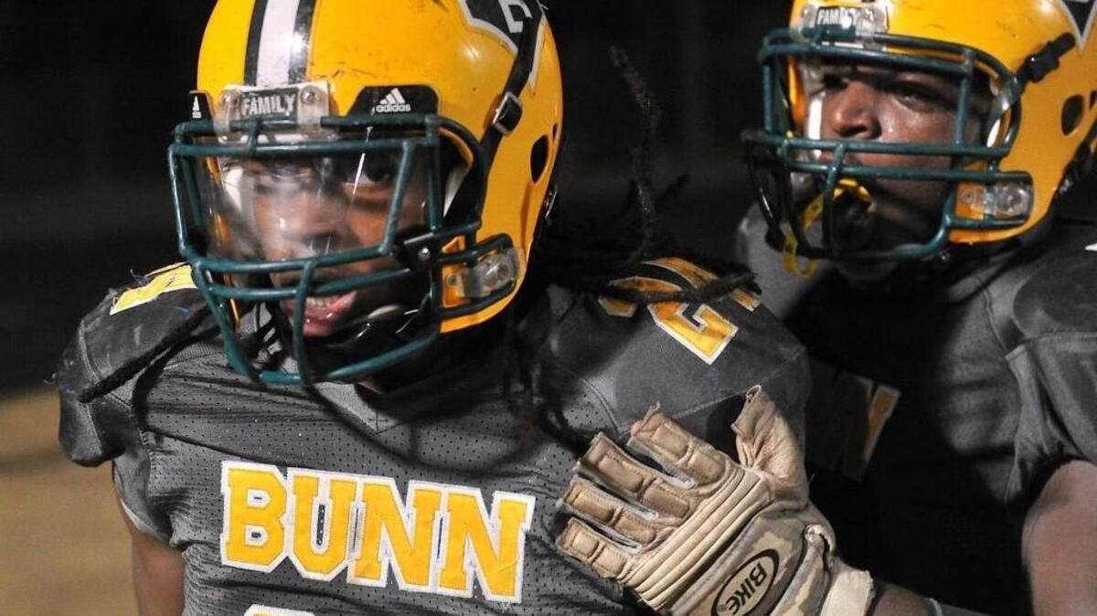 Bunn's Tevin Perry (24) is congratulated by teammate Dillon Hopkins (50) after the touchdown which put Bunn ahead for the victory.The East Duplin Wildcats took on the Bunn Panthers in the NCHSAA 2AA third round playoff game in Bunn, N.C. on Friday, November 27, 2015. Bunn wins 36-29.
