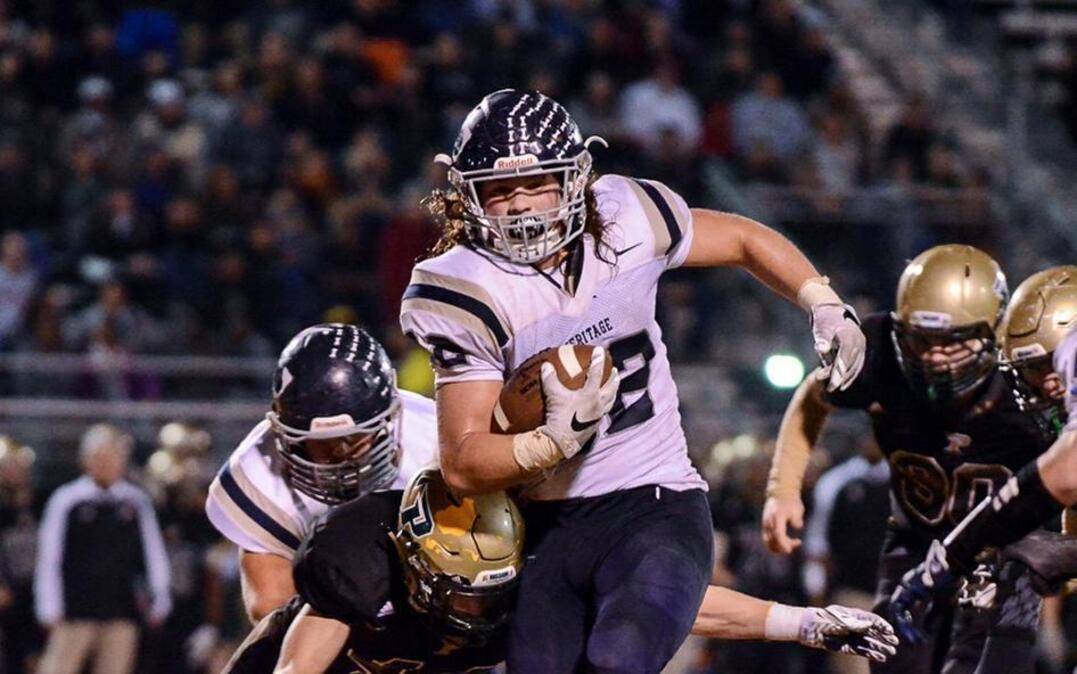 Heritage's Drake Thomas (32) chews up yardage and time in the 4th quarter during Heritage's second round playoff game at Pinecrest on Friday November 25,2016 in Southern Pines, NC.