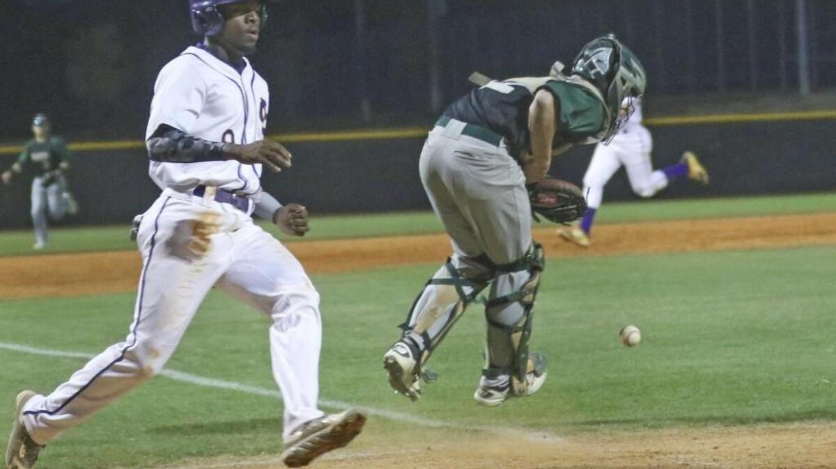 Corinth Holders’ Kahlil Hodge (9) plates a run in the to get the Pirates on the board as South Johnston catcher blocks the throw.