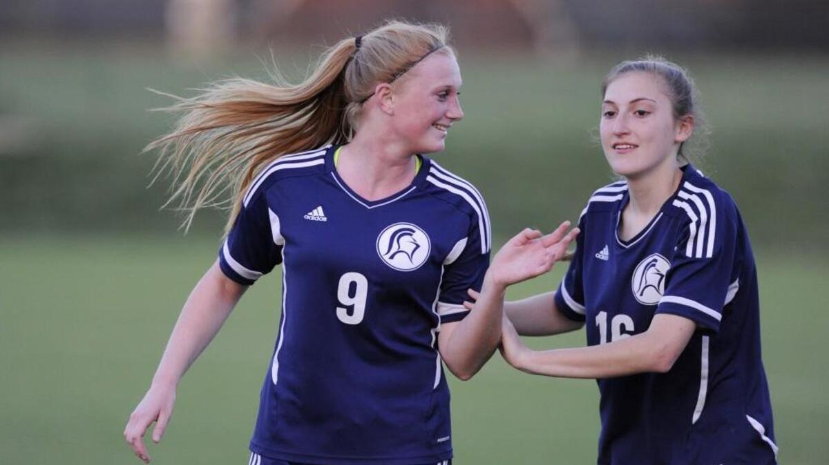 North Raleigh Christian Academy's Lilli Pitre (9) and Ciara Brown (16) celebrate their win over Ravenscroft in Raleigh, N.C. on Thursday, March 24, 2016. North Raleigh Christian Academy won 2-0.