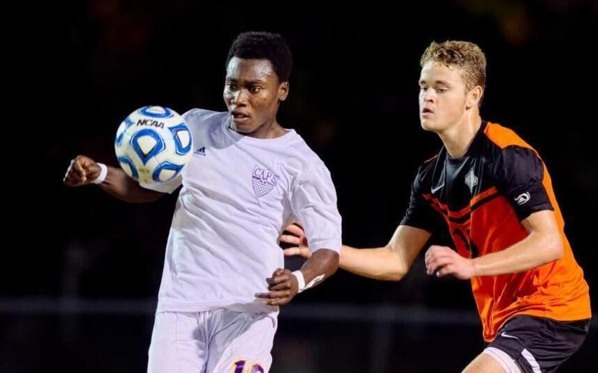 
Broughton’s Elvis Wiredu (18) eyes the ball in front of New Hanover senior Ian Bennett (10) during the second half. The New Hanover Wildcats played the Broughton Capitals in the fourth round of the NCHSAA 4A Men's Soccer playoffs on Tuesday, November 12, 2014 in Raleigh, N.C. Broughton won the game, 5-2.
