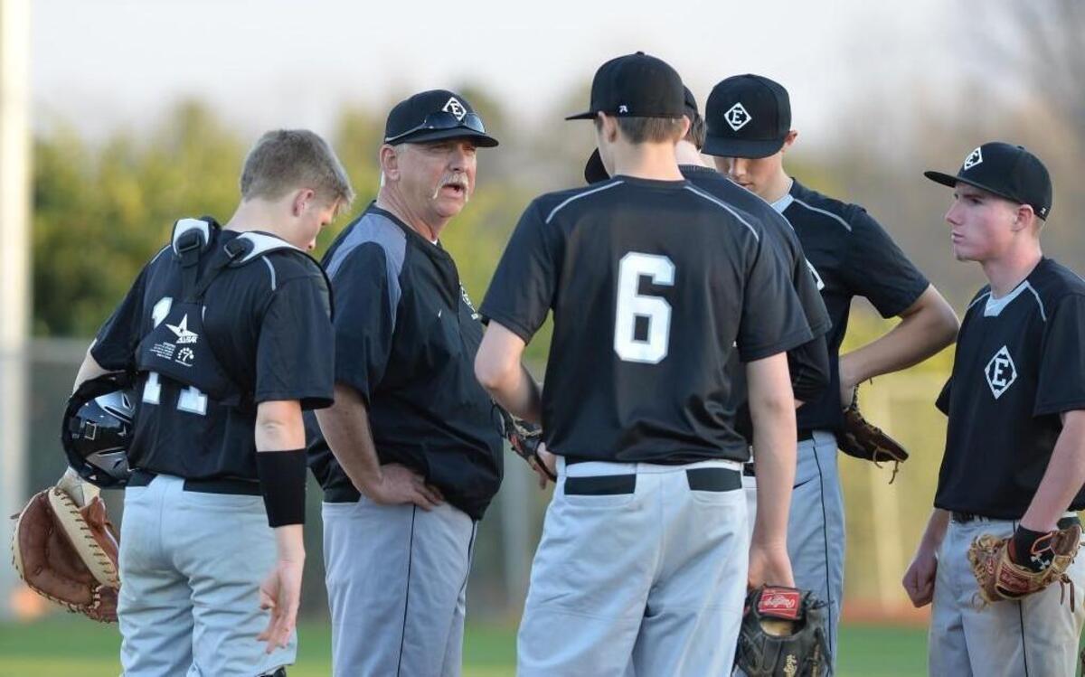 East Chapel Hill coach Phil Woodell, second from left, called the game ‘ugly’ but was happy to get the win after chasing it for two days and 13 innings.