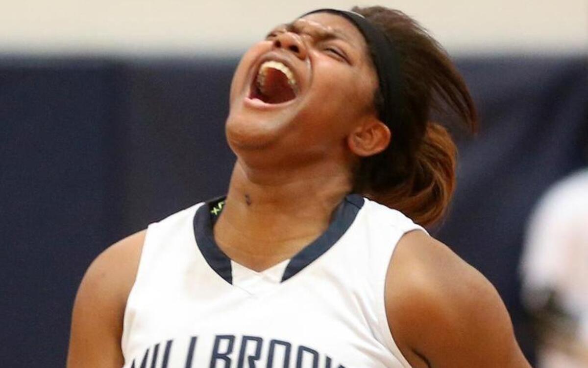 Millbrook's L'Donnisty Granison (30) celebrates the Wildcat victory in the 4th round of the girls NCHSAA 4A basketball playoffs between the Millbrook High Wildcats and the Southeast Raleigh High Bulldogs played in Raleigh, N.C. on Tuesday, March 1, 2016. Millbrook defeated Southeast Raleigh 51-47 to advance in the playoffs.