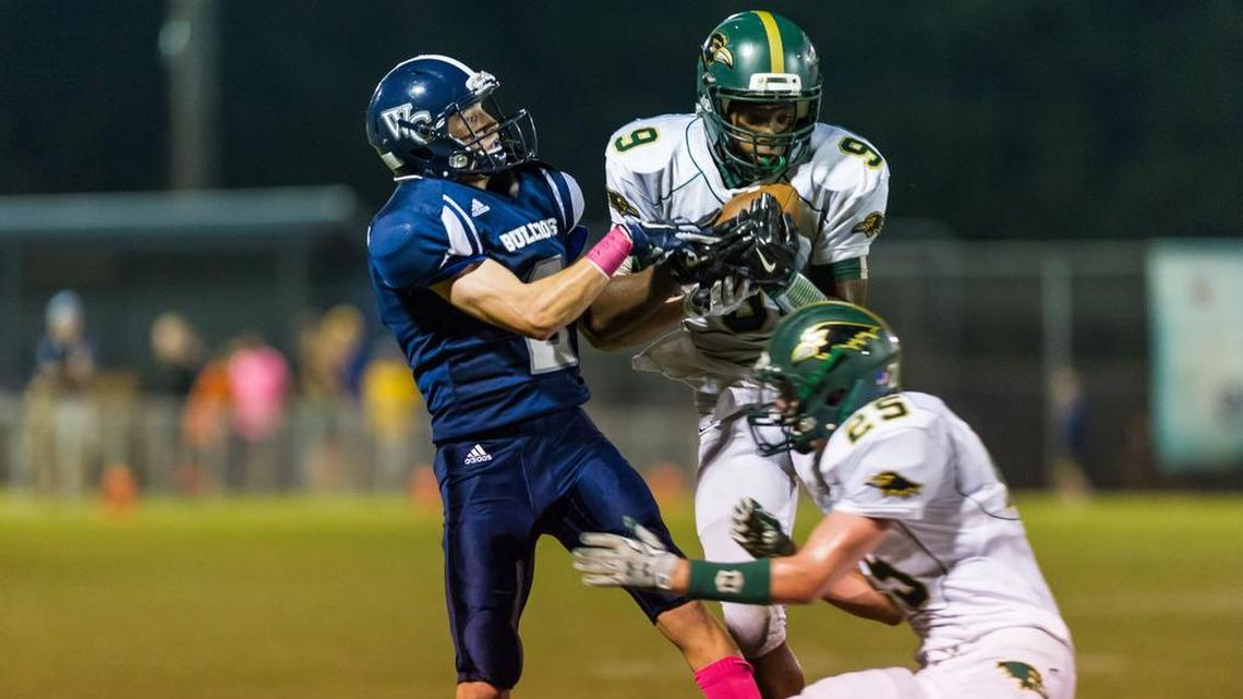 
Ravenscroft defensive back Devon Perry (9) intercepts the ball intended for Wake Christian Academy wide receiver John Kirkpatrick (2) as Ravenscroft takes on Wake Christian Academy at Wake Christian Academy on Friday, October 9, 2015.
