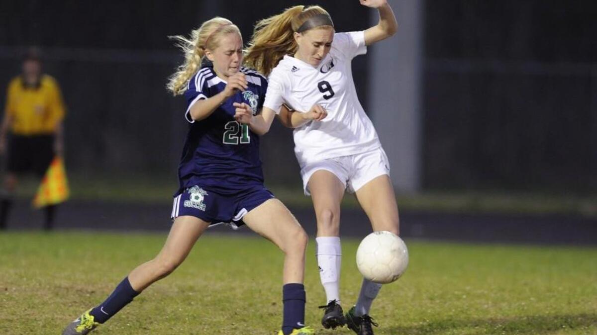 Leesville Road's Brooke Sroka (21) and Heritage's Christiana Filippini (9) go after the ball in Wake Forest, N.C. on Monday, March 14, 2016. The game ended in a tie 0-0.