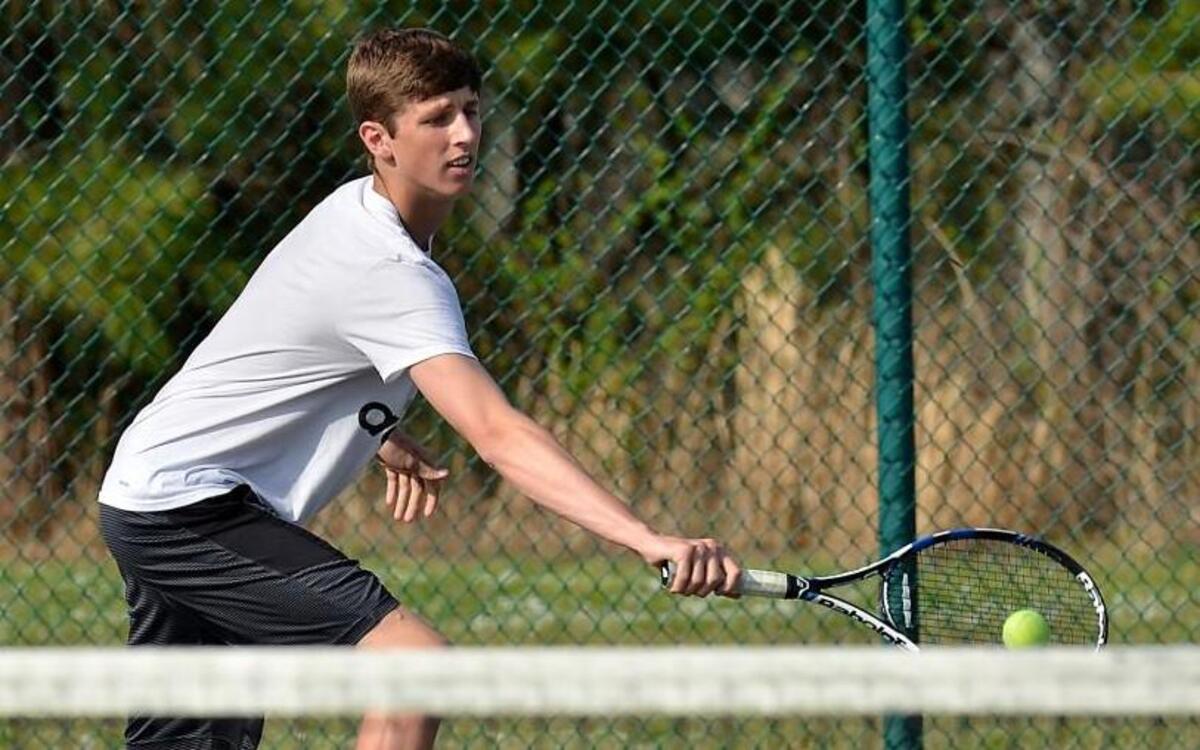 East Wake’s Brooks Stancil connects on a one-handed backhand during the Warriors’ Greater Neuse River 4A Conference boys tennis match at Knightdale High School in Knightdale, N.C. Wednesday, March 16, 2016.