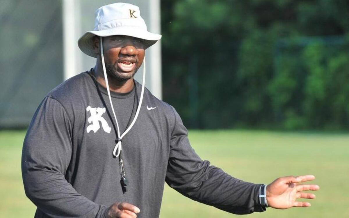 Knightdale head football coach Cedric Dargan directs players during an offensive drill. The Knightdale Knights took to field for football practice in Knightdale on Aug. 6, 2014.