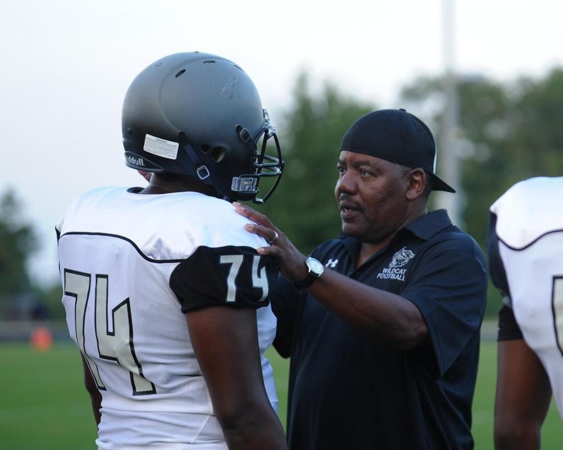 East Chapel Hill coach, Ray Hartsfield, talks to Marquette Bowers (74) during the JV football game between the East Chapel Hill Wildcats and the Carrboro Jaguars, which was played in Carrboro on Thursday, August 24, 2017.