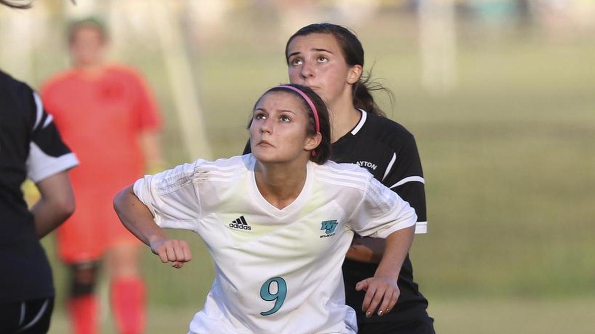 West Johnston's Robin Pollard (9) shields the incoming ball from Clayton's Riley Mann (22). Coverage from the girls soccer between the Clayton Comets and the West Johnston Wildcats played in Benson, N.C. on Wednesday, April 26, 2017. Clayton defeated West Johnston 3-2 in overtime to clinch the Greater Neuse River regular season championship.