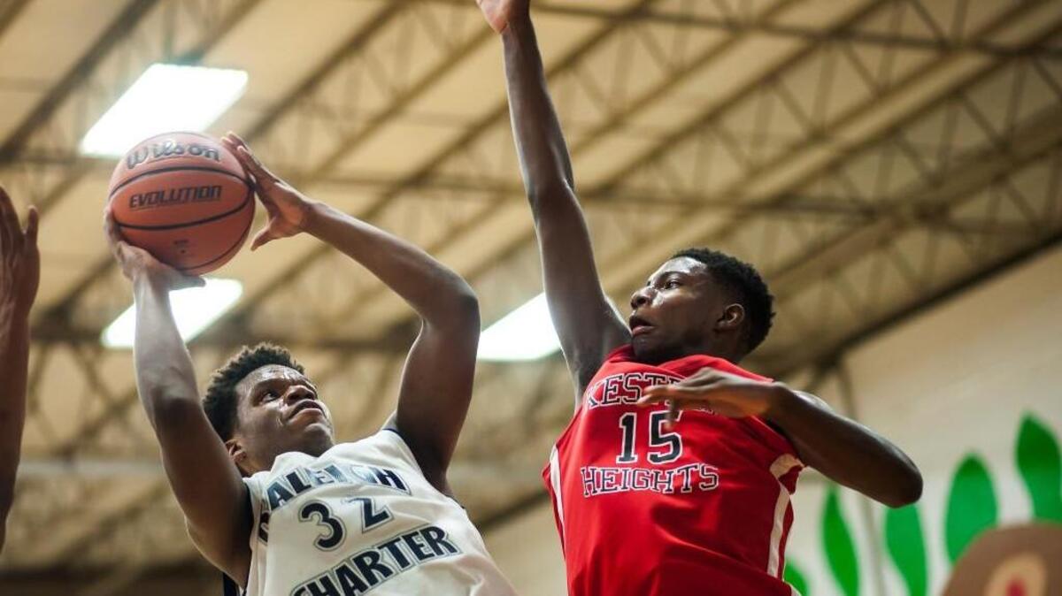 Raleigh Charter's Jordan Bell (32) attempts a shot over Kestrel's Marcotis Hall (15) during a boys basketball game on Friday, December 18, 2015 in Raleigh, N.C. The Kestrel Heights' boys won 46-39.