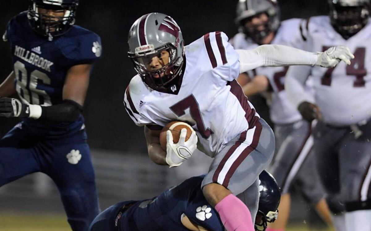 
Wakefield's Andrew Bennett (7) is tackled by Millbrook's Justin Sauer (6) in Raleigh, N.C. on Friday, October 16, 2015. Wakefield won 32-21.
