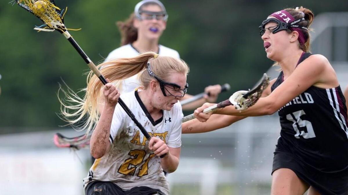 Graci Fulkerson (21), from Apex battles Julie Anne Pretty (15) from Wakefield. Apex Cougars played the Wakefield Wolverines in the girls LAX game which was played in Apex on Friday, May 7, 2016. Wakefield won 16-8.