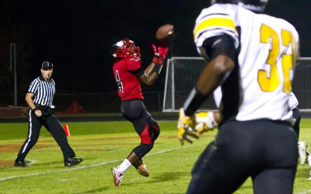 Mustang Dareke Young on the receiving end of a touchdown pass. The Apex Cougars and Middle Creek Mustangs football game in Apex, N.C. on Friday, November 11, 2015. Middle Creek won 41-9.