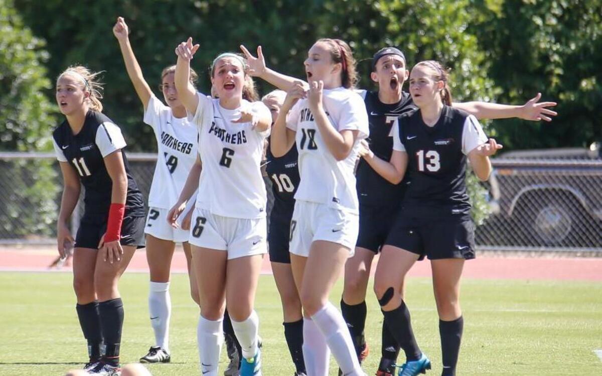 Players from Middle Creek, in black, and Providence, in white, react to the offsides call that waved off a tying Middle Creek goal scored in the final seconds of regulation during the NCHSAA 4A State Championship girls soccer game between Charlotte Providence and Middle Creek in Raleigh on Saturday, May 28, 2016. Providence won the game 2-1.
