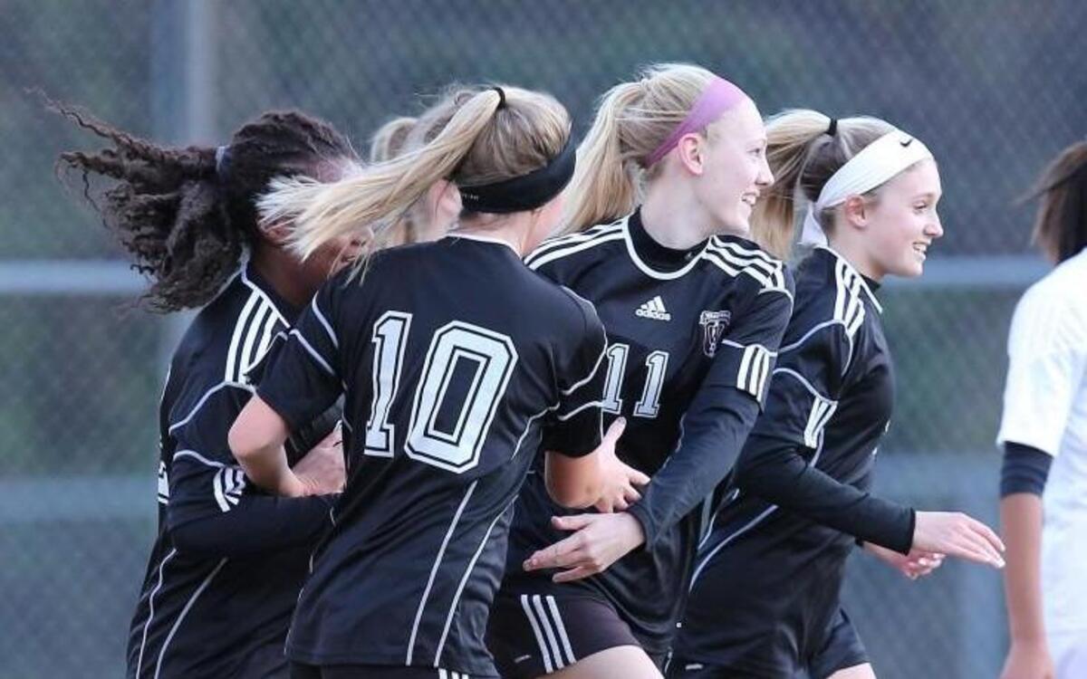 Wakefield's Tori Hansen (11)gets congratulated by her teammates after she scores during the Sanderson Spartan high school soccer game with the Wakefield Wolverines high school , March 16, 2017, in Raleigh , N.C.