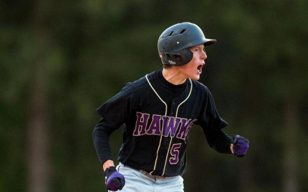 Holly Springs centerfielder Patrick Wheeler celebrates after arriving safely at second base during the seventh inning of a high school baseball game against Green Hope in Cary, N.C. on Friday, April 8, 2016.