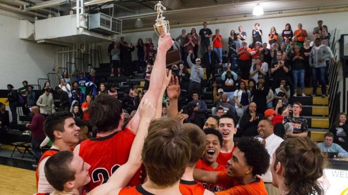 The Panthers hoist the trophy to show the fans.