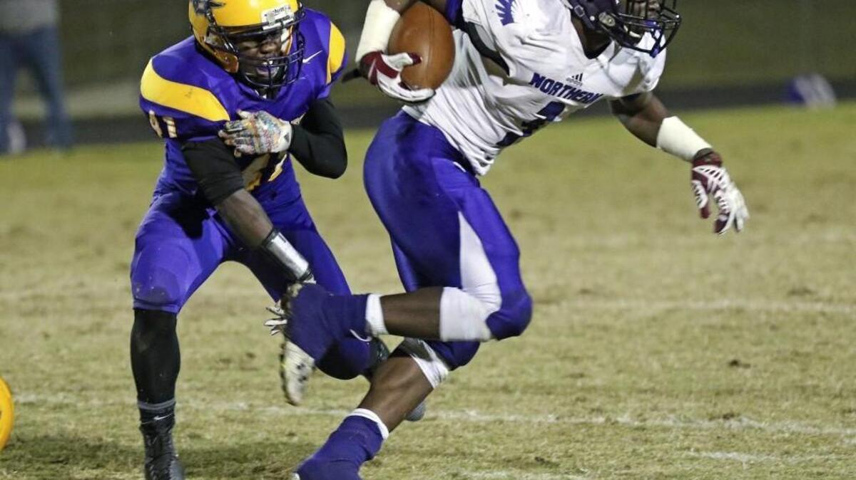 Northern Guilford’s Caleb Freeman (3) breaks the tackle of Samuel Baily (41) of Corinth Holders and goes 65 yards in the second quarter for a touchdown.