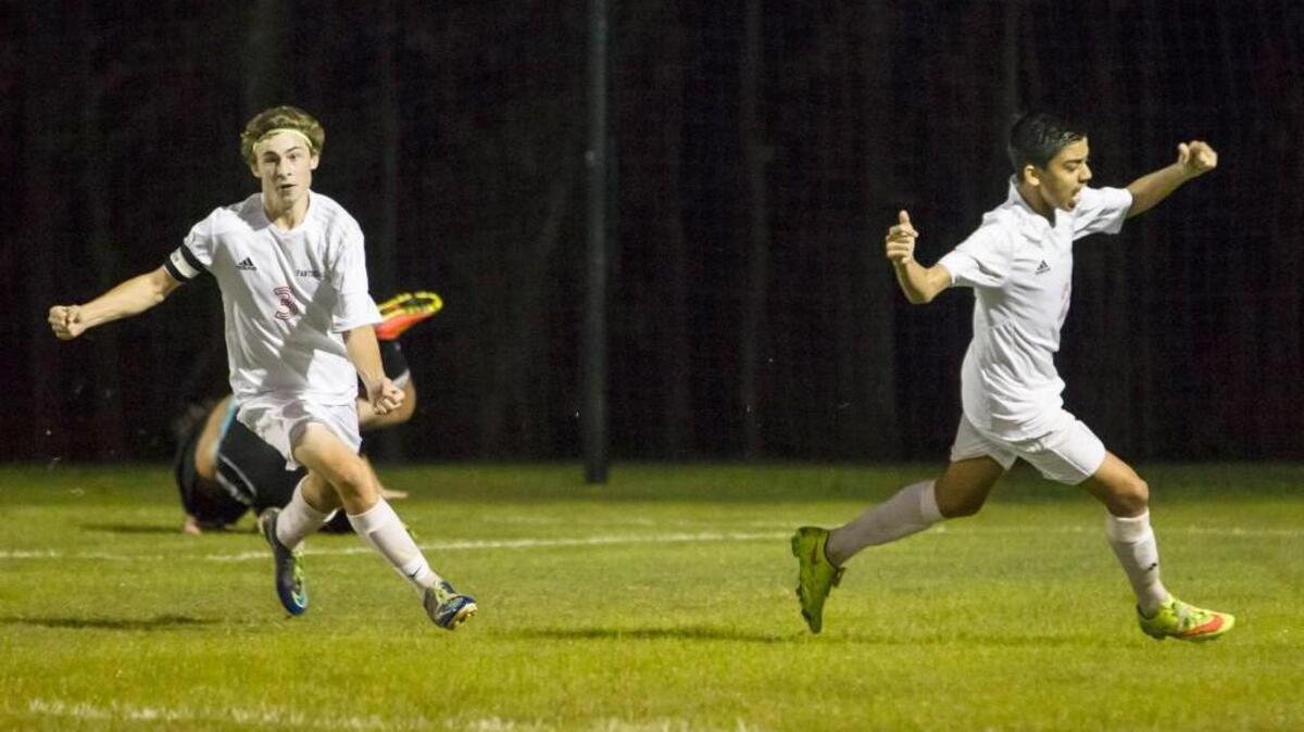 North Johnston’s Chase Davis (3) and Carlos Aguilar (2) celebrate a goal during the Panthers’ second-round playoff win over North Lenoir.