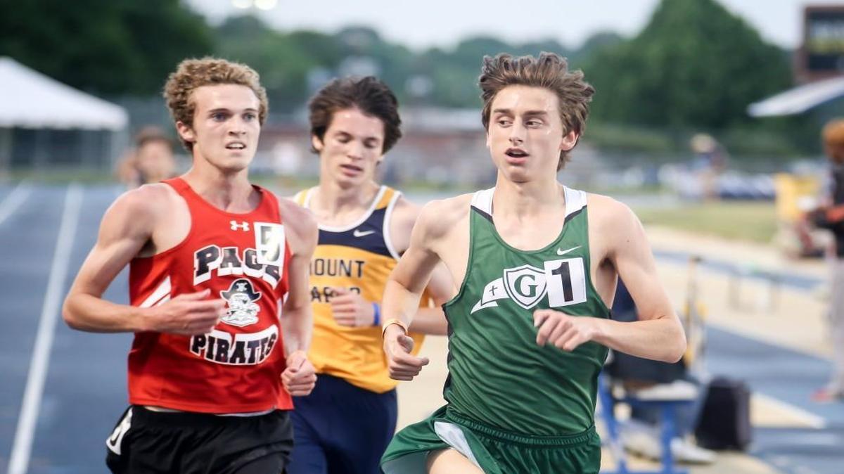 Cardinal Gibbons' Connor Lane looks to see how close his competitors are as he runs and wins the 3200 meter run with a new state record of 8:59.90 during the NCHSAA 2A and 4A track and field state championships in Greensboro on Friday, May 19, 2017.