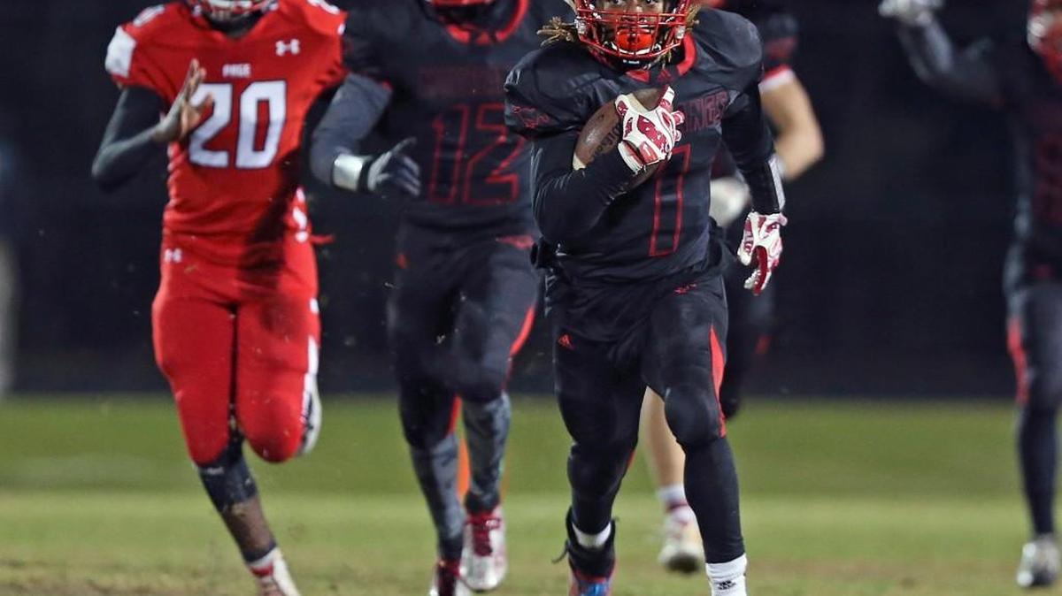 Middle Creek’s Johnathan Spencer (1) runs back a punt for 91 yards late in the second quarter to set up the first Mustang score. Coverage from the Eastern Regional 4AA NCHSAA Football Championship game between the Middle Creek Mustangs and the Greensboro Page Pirates played in Apex, N.C. on Friday, December 04, 2015. Greensboro Page leads at the half 21-10.