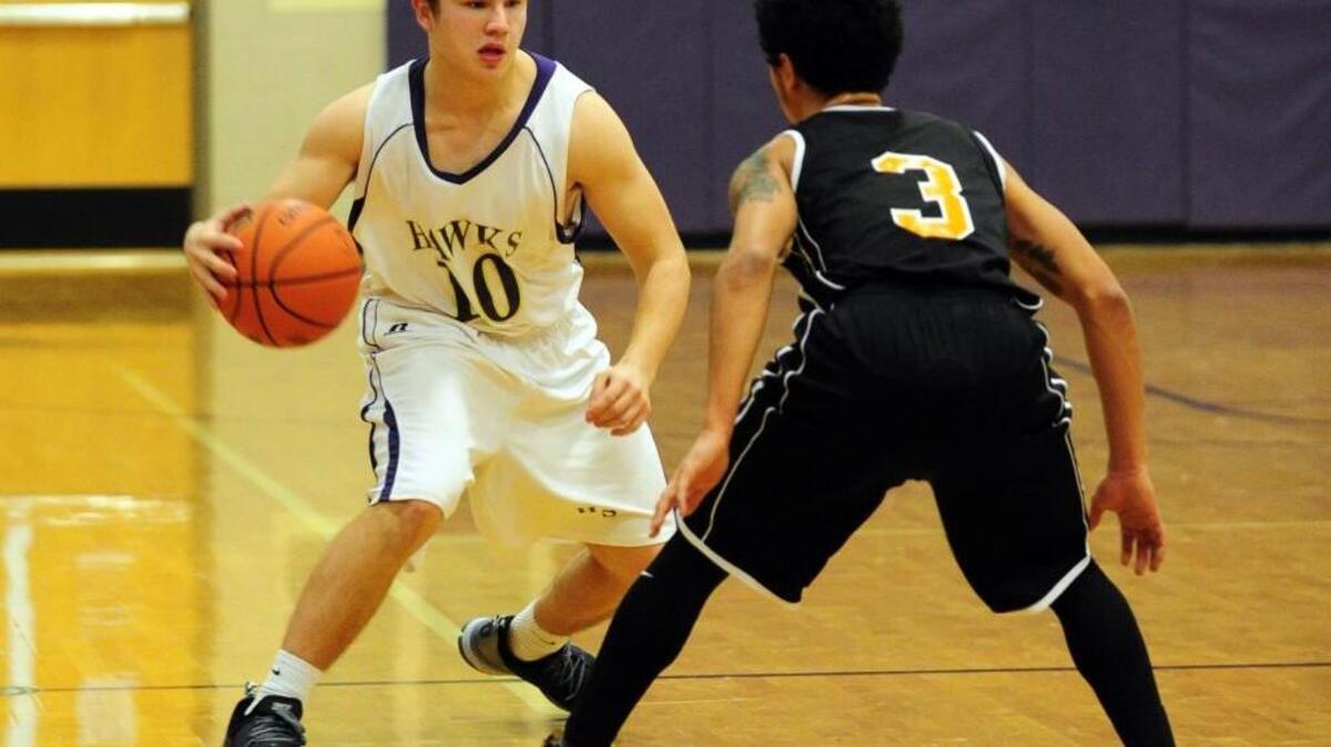 Holly Springs' Davis Ferguson (10) is challenged by Fuquay-Varina's Taylor Layton (3) during the boys basketball game, which was played in Holly Springs Tuesday, January 26, 2016. Fuquay-Varina won 57-52.