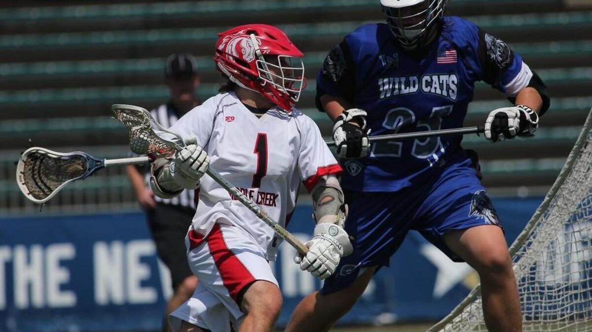 Middle Creek's Jared Medwar (1) tries to get around Lake Norman's Sean Riley (25) during the Middle Creek Mustangs high school Lacrosse match with the Lake Norman Wildcats high school in the State Championship 4A-game in Cary N.C. on May 20, 2017. Middle Creek won the game 17-8.