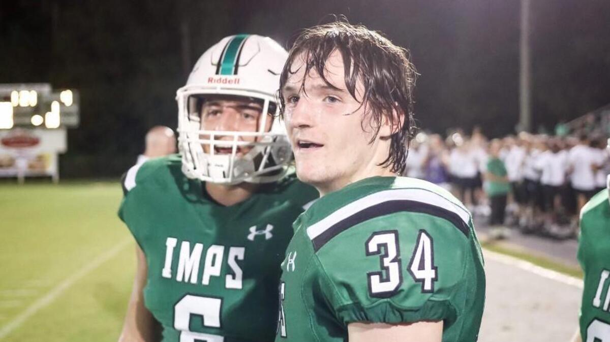 Cary defensive back Justin Rodgers (34) talks with teammate Zachary Wagner (6) during Cary's season-opening win on Friday, August 18, 2017.