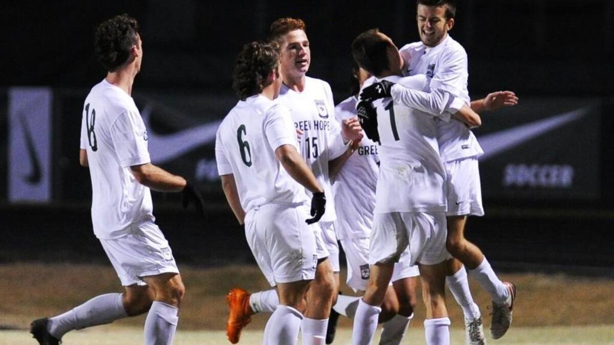 Anthony Boswell (far right) celebrates his overtime goal with his teammates during the NCHSAA third round boys soccer playoff game against Millbrook, which was played on Thursday, November 10, 2016 in Cary. Green Hope won 3-0 in overtime.