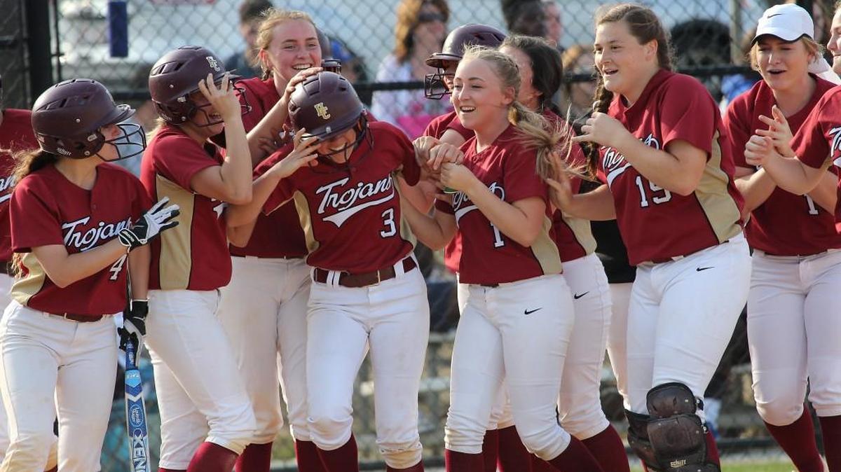 Harnett Central's Hayley Waddell ( 3) is all smiles as her team congratulates her after her home run during the Harnett Central Trojans high school softball game with the Garner Magnet Trojans high school , March 30, 2017, in Raleigh, N.C. Garner won 14-11.