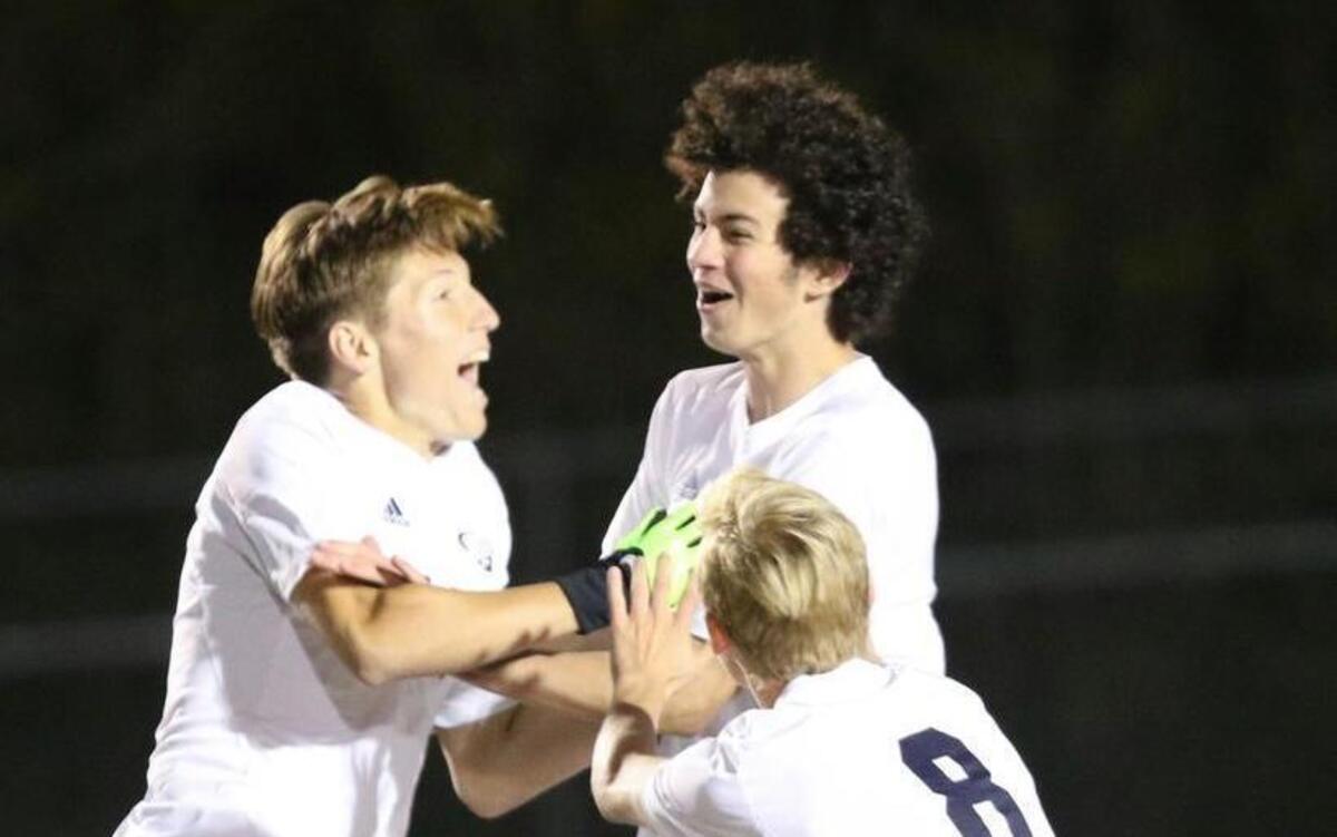 Heritage's Trevor Berk (left) and Caleb Bratager (8) celebrate James Simpson's (middle)goal with just over a minute into the game. Coverage from the 1st Round of the NCHSAA 4A boys soccer tournament game between the Cary Imps and the Heritage Huskies played in Wake Forest, N.C. on Saturday, November 5, 2016. Cary defeated Heritage 3-2 in overtime.