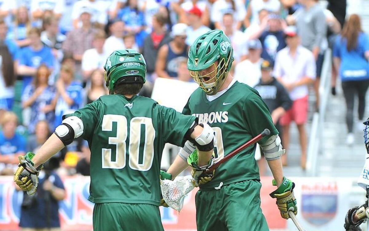 Cardinal Gibbons' Connor Scanlin (30)celebrates with teammate Kevin Barry (29) after he scores a goal. The Lake Norman Wildcats and the Cardinal Gibbons Crusaders met in the finals of the NCHSAA 4A lacrosse championships at WakeMed Soccer Park in Cary, N.C. on May 21, 2016. Cardinal Gibbons wins 14-8. Cardinal Gibbons wins 14-8.