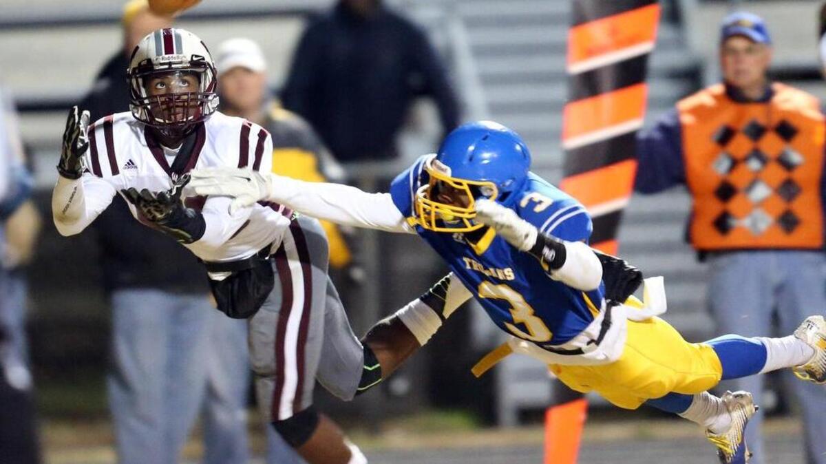 
Wakefield's Dontel Dunston (88) keeps a eye on the ball as Garner's Raekwon Britton (3) defends during the Wakefield High School Football game against Garner Magnet High School in the second round of the NCHSAA playoffs on November 21, 2014 in Garner, N.C. Garner leads at the half 28-0.

