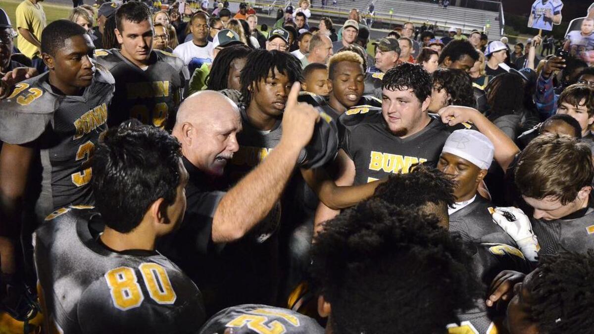 Bunn High School head football coach David Howle (center left), fans and Wildcats players celebrate a 69-32 win over Warren County, a Northern Carolina 2A Conference title and Howle's 200th career victory as Bunn's head football coach in Bunn, N.C. Friday, Nov. 6, 2015.
